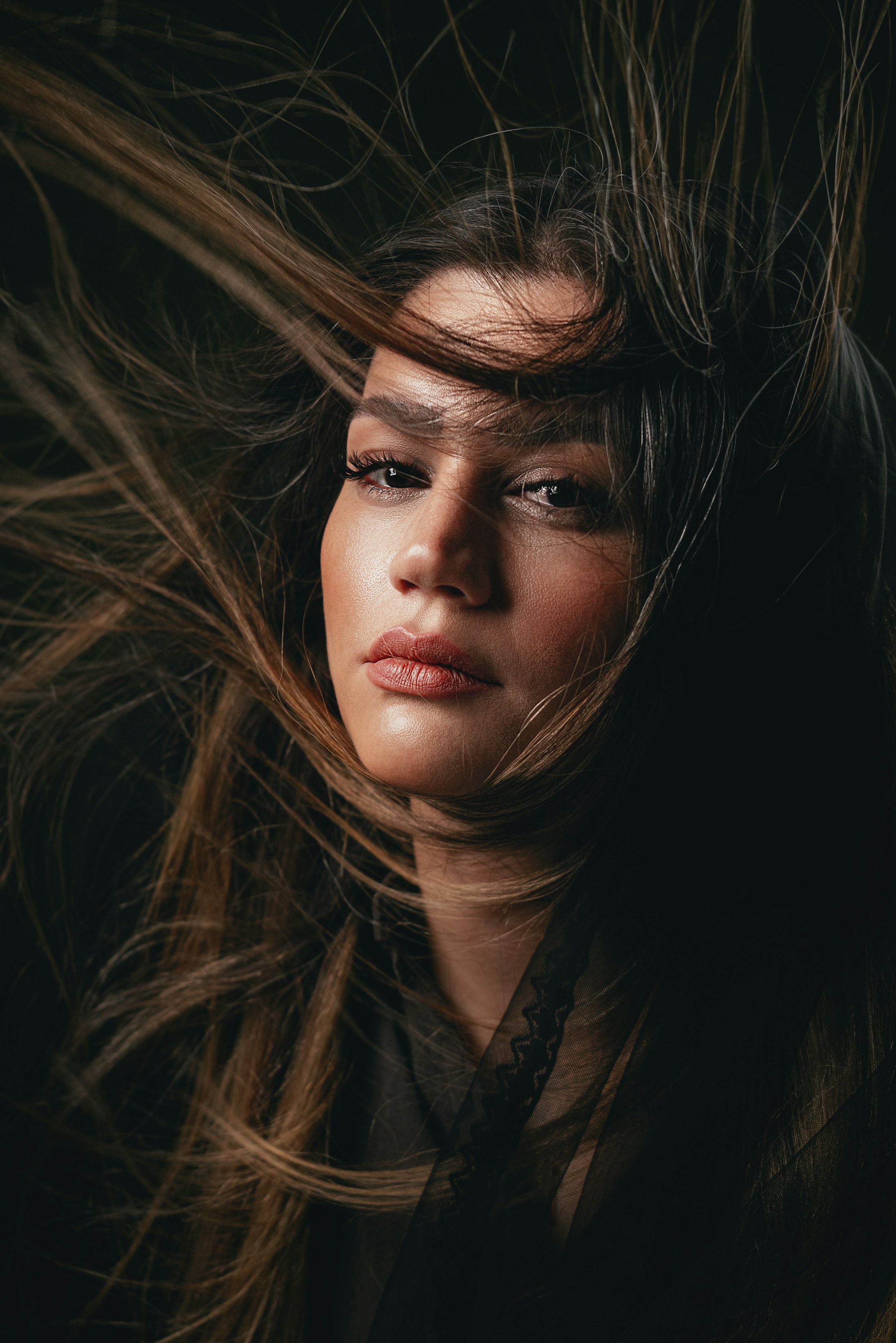 Woman with long brown hair moving softly